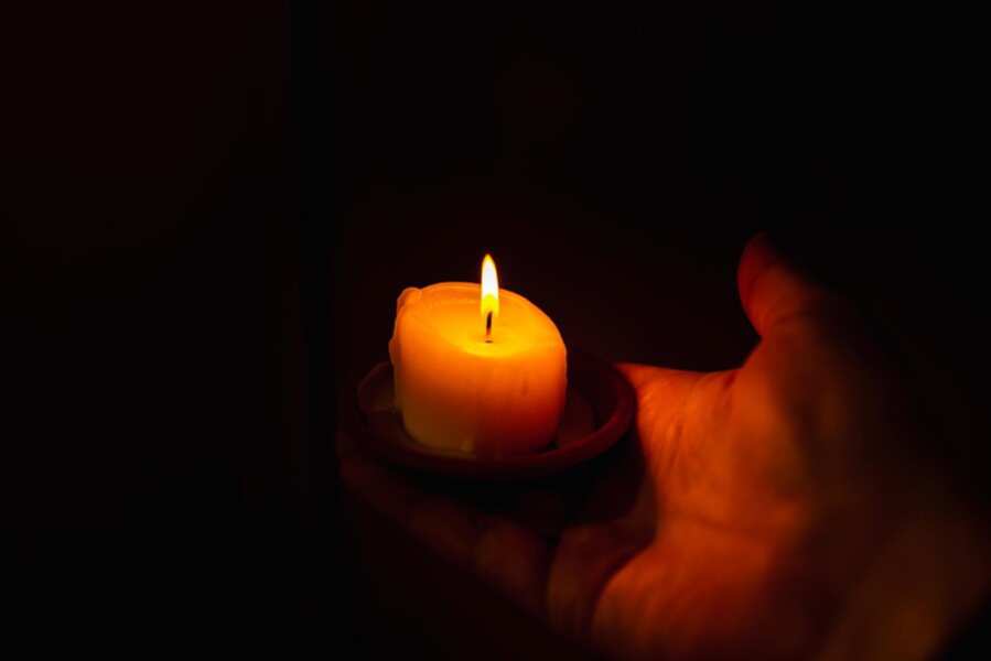 burning-candle-mans-hand-dark-backgrounda-man-prayer burning-candle-mans-hand-dark-backgrounda-man-prayer