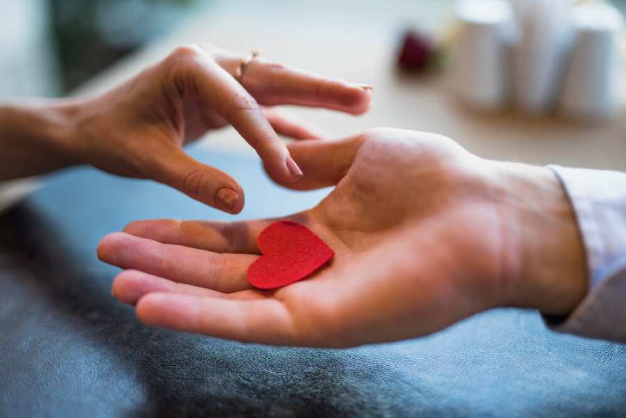man-giving-red-ornament-heart man-giving-red-ornament-heart