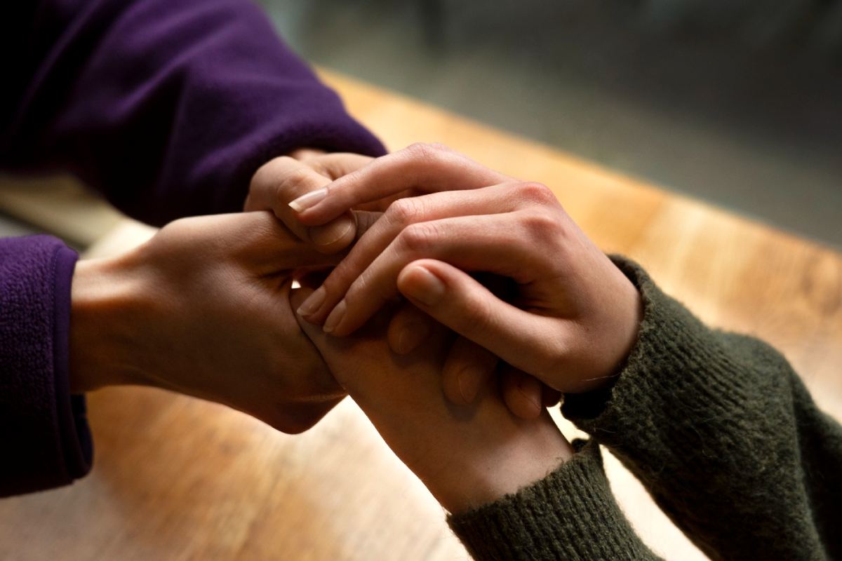 Hands holding each other for support