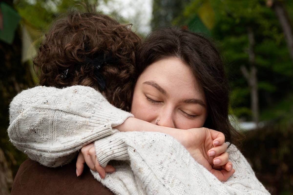 Side view friends hugging in nature